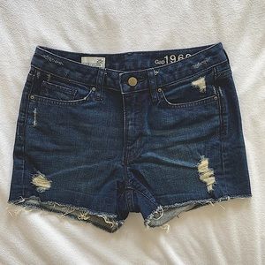 Mid-rise distressed denim shorts